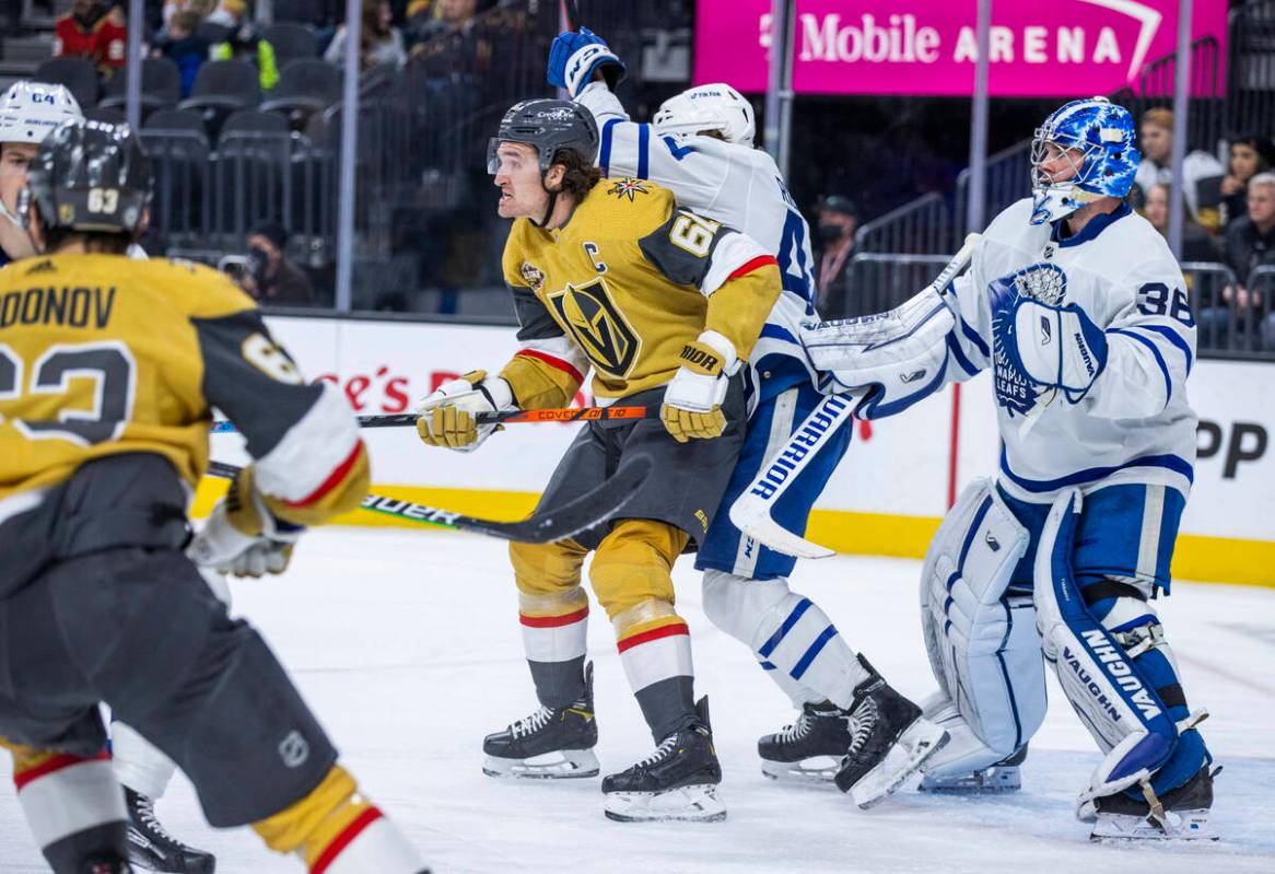 Golden Knights right wing Mark Stone (61) fights for position near the net with Toronto Maple L ...