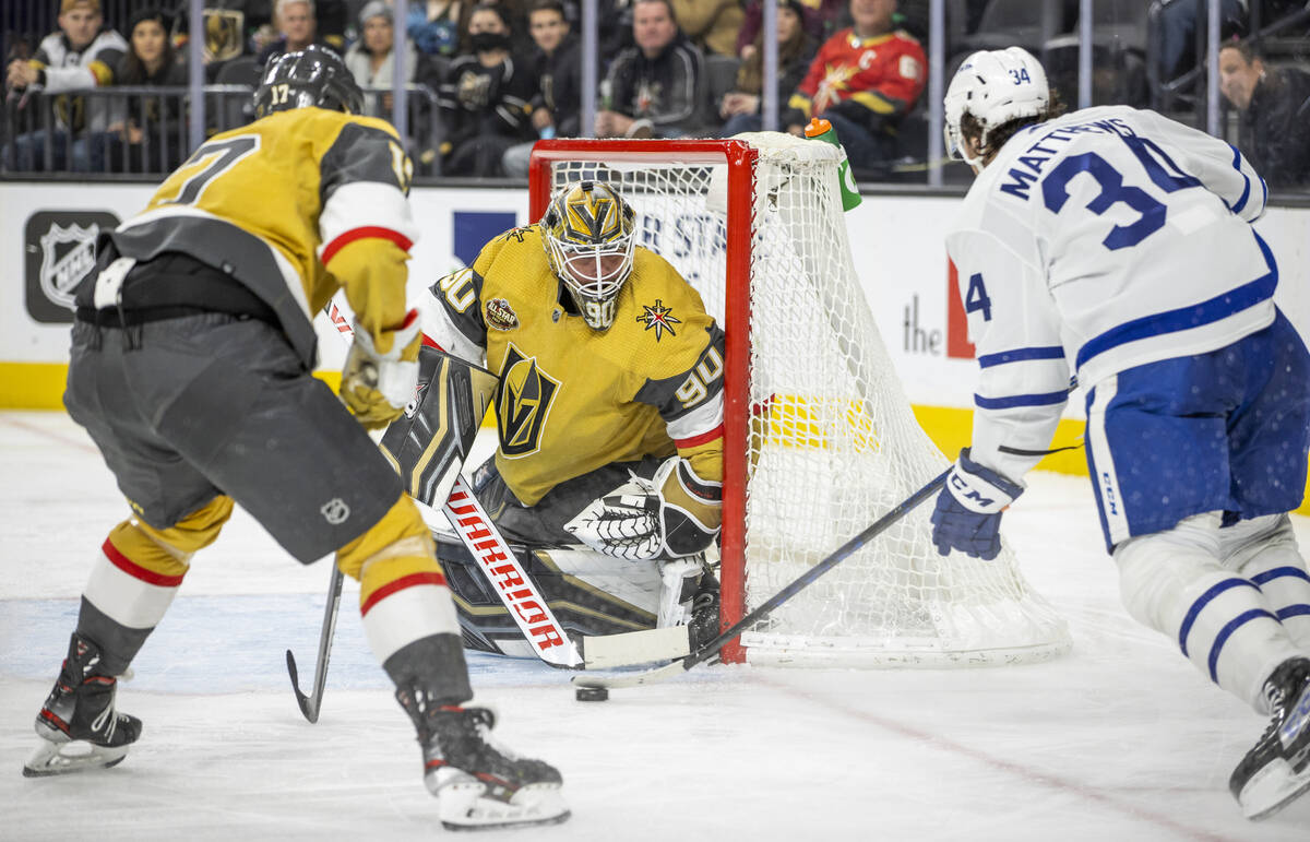 Golden Knights goaltender Robin Lehner (90) looks to Toronto Maple Leafs center Auston Matthews ...