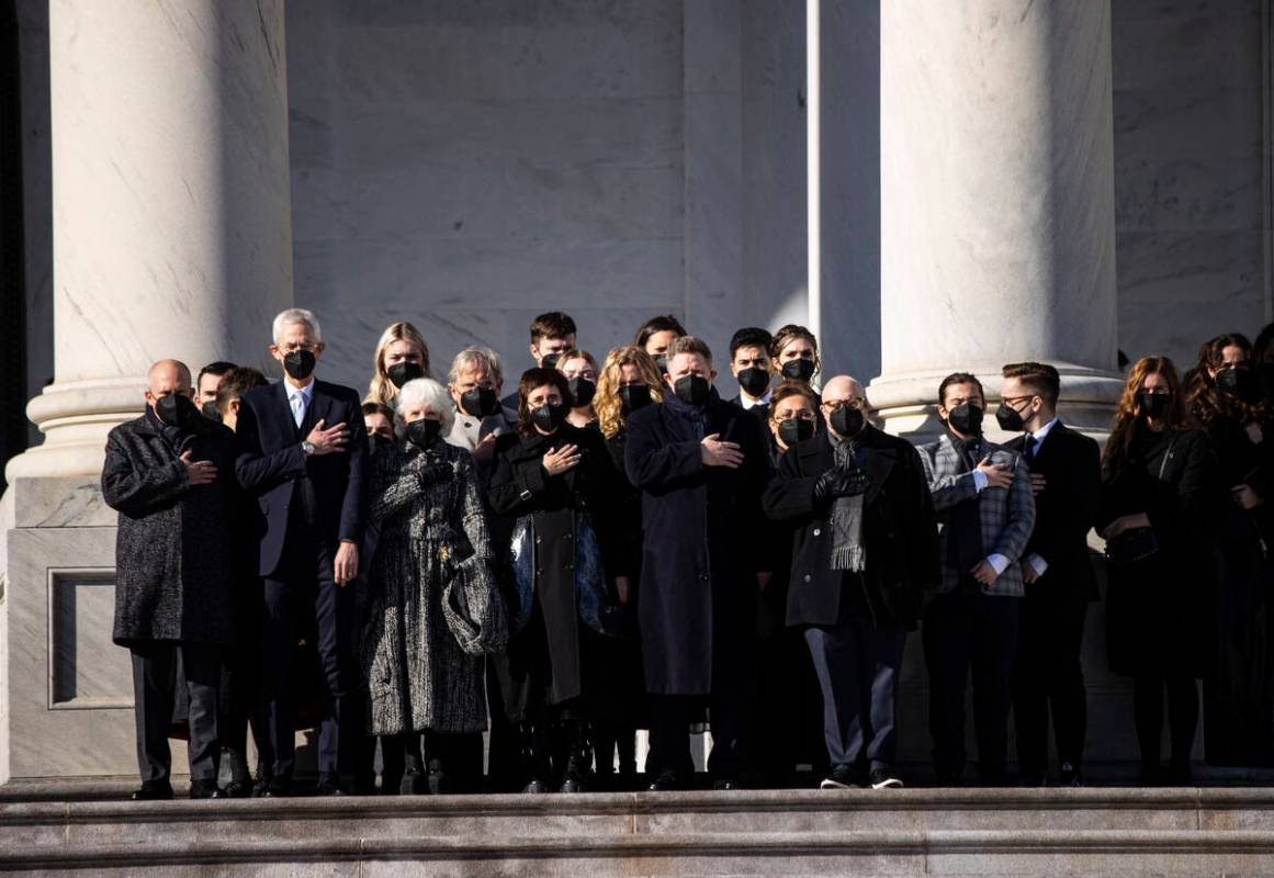 Family members of the late U.S. Sen. Harry Reid watch as a military honor guard carries the fla ...