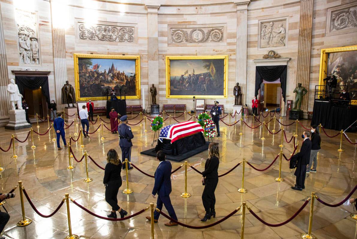 People pay their respects while viewing the flag-draped casket of former Sen. Harry Reid as he ...