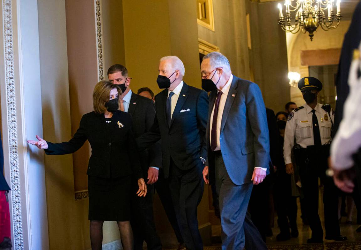 President Joe Biden, center, walks with House Speaker Nancy Pelosi, of Calif., left, and Senate ...