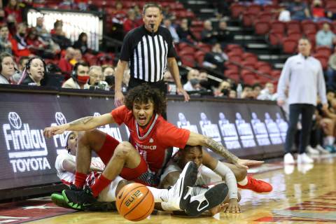 UNLV Rebels forward Donovan Williams, left, and guard Josh Baker, right, fight for the ball wit ...