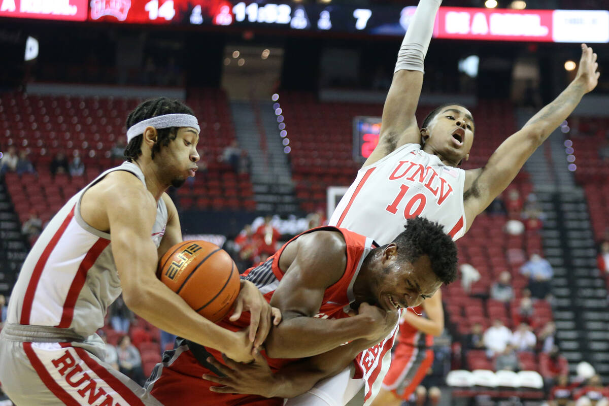UNLV Rebels guard Justin Webster (2) gains control of the ball from New Mexico Lobos guard Jama ...
