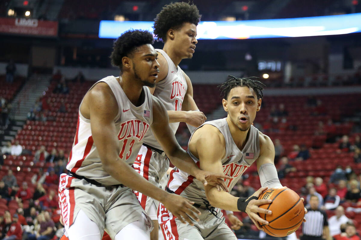 UNLV Rebels guard Marvin Coleman (31) recovers the ball next to guard Bryce Hamilton (13) and c ...