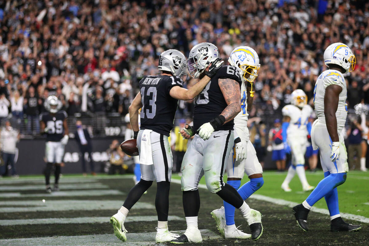 Raiders wide receiver Hunter Renfrow (13) celebrates his touchdown with center Andre James (68) ...