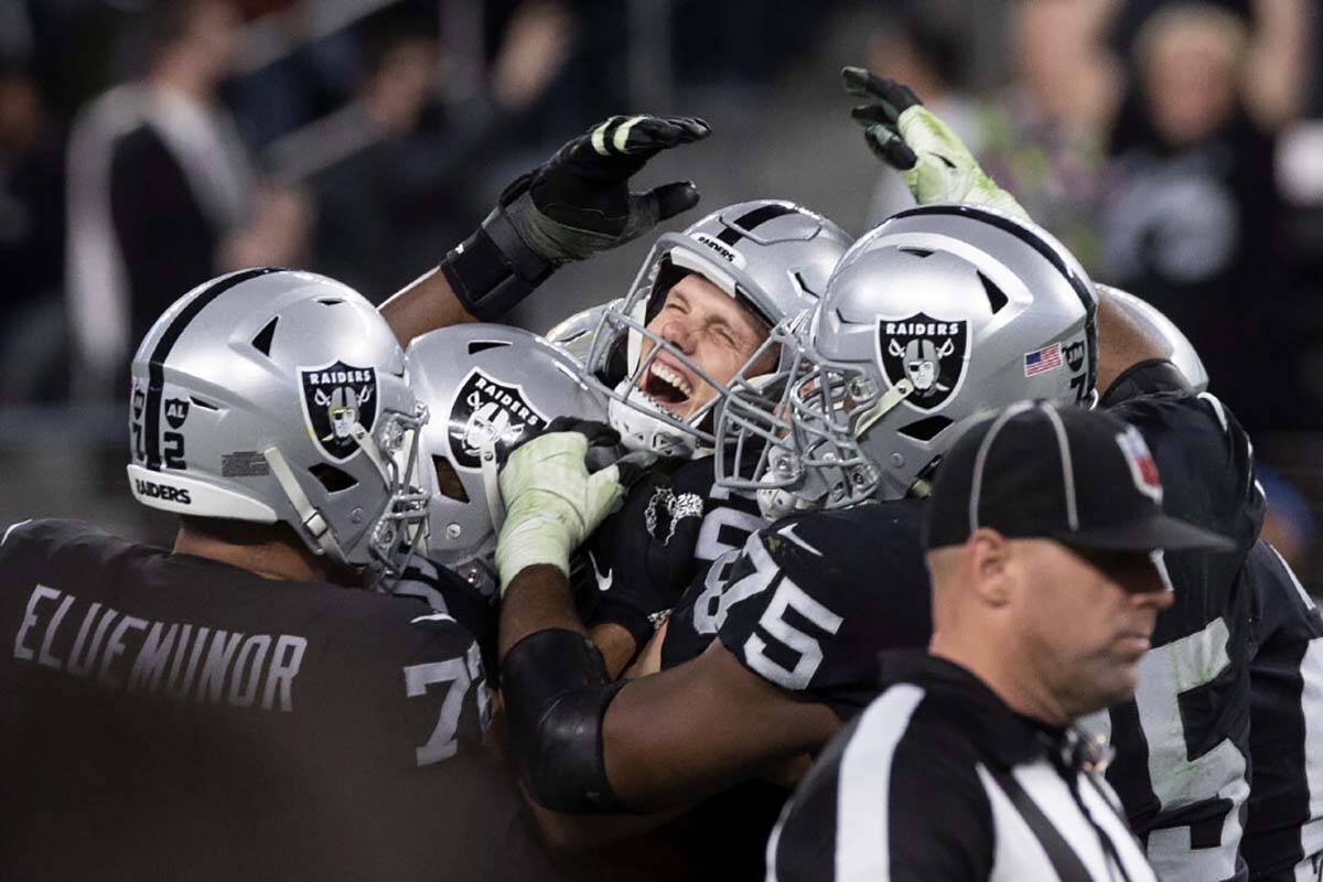 Raiders kicker Daniel Carlson, top/middle, celebrates after kicking the game winning field goal ...