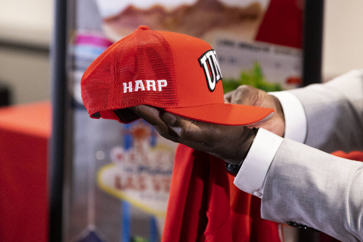 Erick Harper shows a custom hat he received following a press conference announcing him as the ...