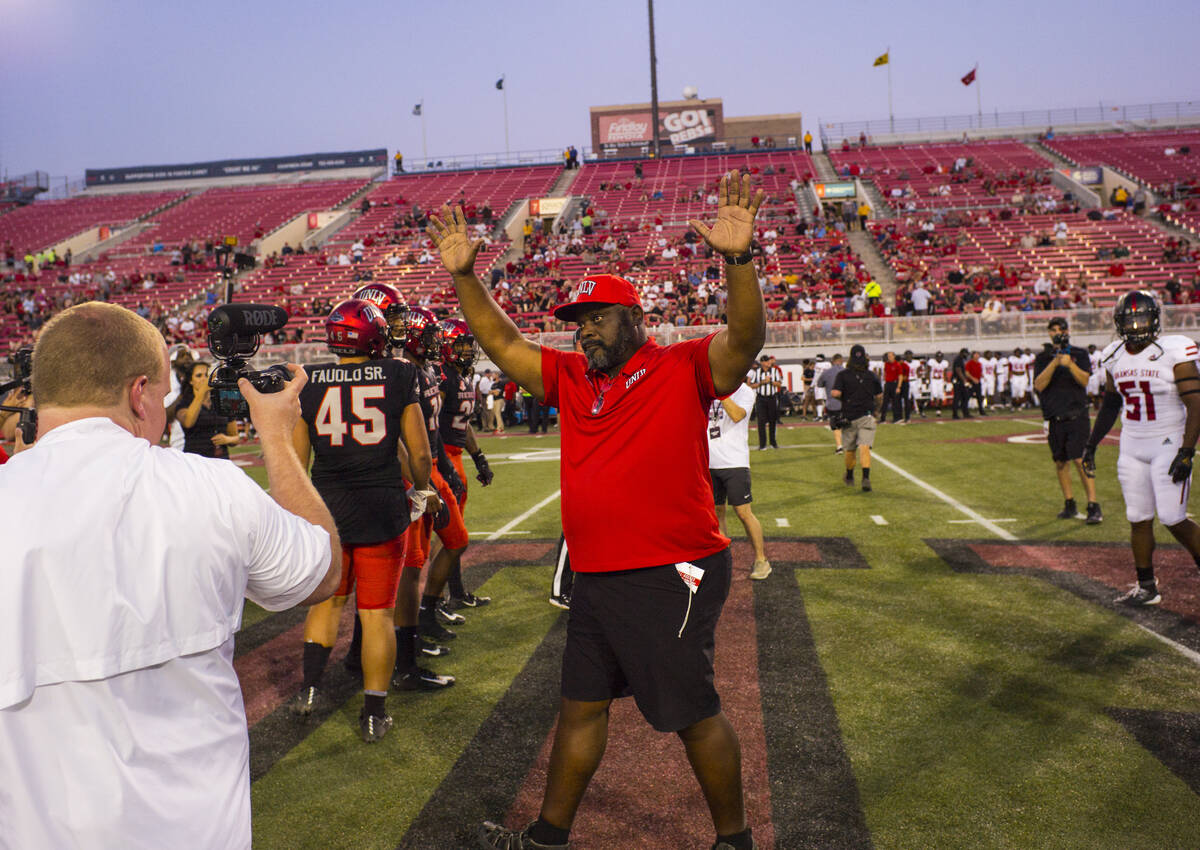 Former UNLV football player Ickey Woods waves at the crowd after participating in the coin toss ...