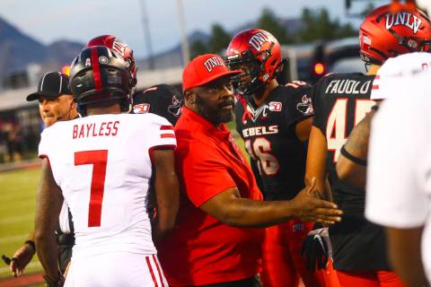 Former UNLV football player Ickey Woods greets players after participating in the coin toss bef ...