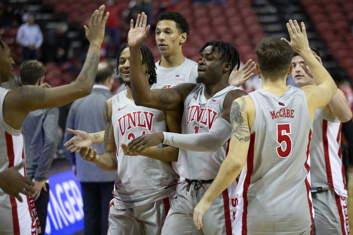 UNLV Rebels players including guard Cameron Burist (34), guard Michael Nuga (1) and guard Jorda ...