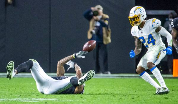 Raiders tight end Darren Waller (83) bobbles a pass from the turf as Los Angeles Chargers safet ...