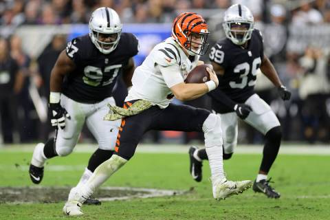 Cincinnati Bengals quarterback Joe Burrow (9) runs the ball against Raiders defensive tackle Da ...