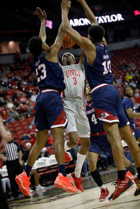 UNLV Rebels forward Donovan Williams (3) goes to the basket as Fresno State Bulldogs guard Leo ...