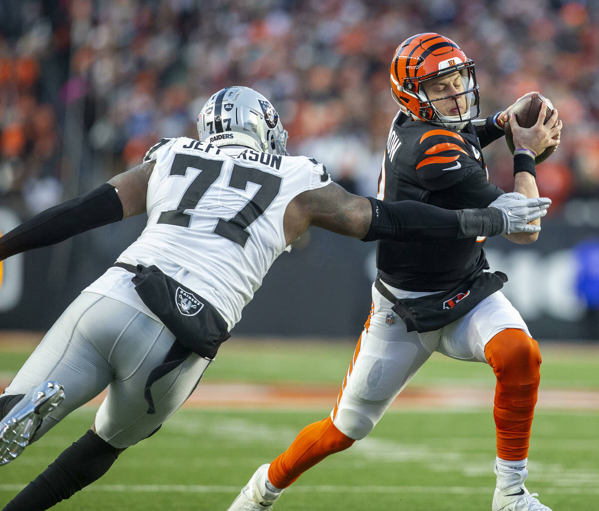 Raiders defensive tackle Quinton Jefferson (77) wraps up Cincinnati Bengals quarterback Joe Bur ...