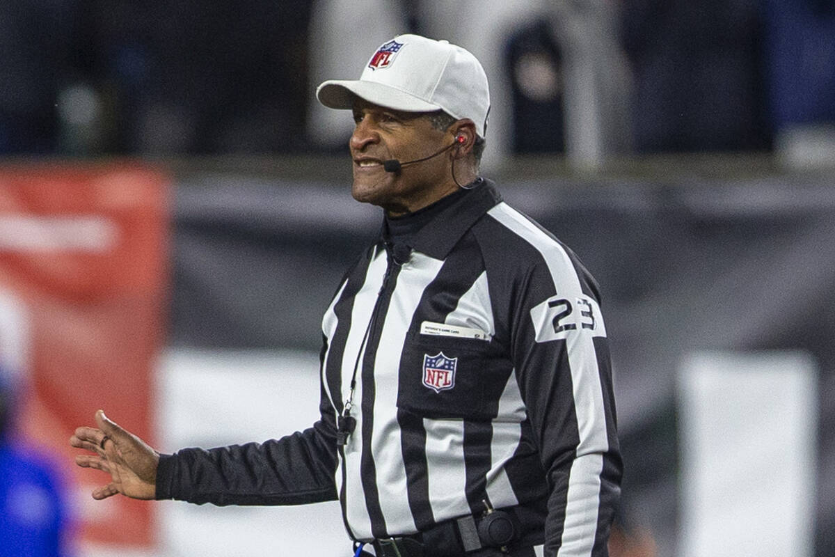 referee Jerome Boger (23) makes a call on a penalty during the second half of an NFL playoff ga ...