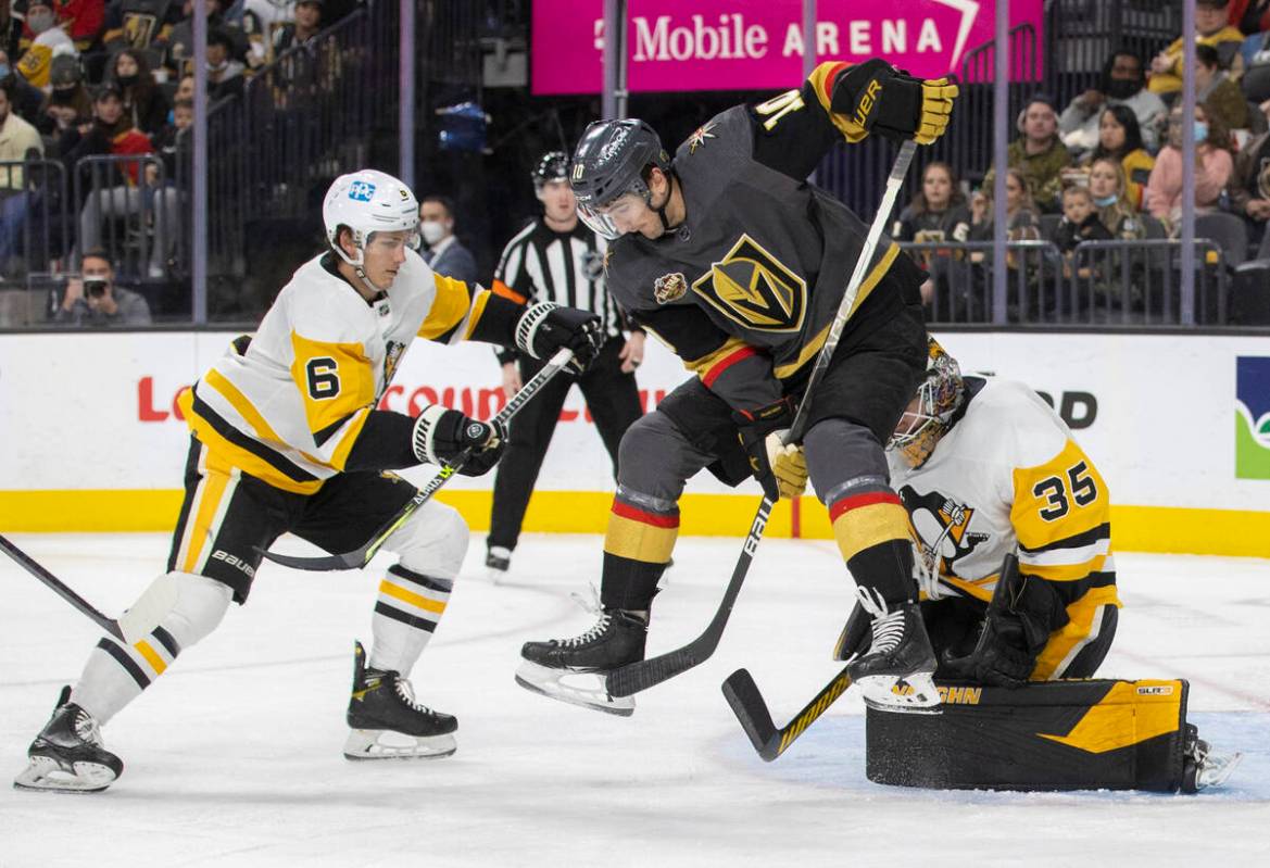 Golden Knights center Nicolas Roy (10) leaps to try and redirect a shot past Pittsburgh Penguin ...