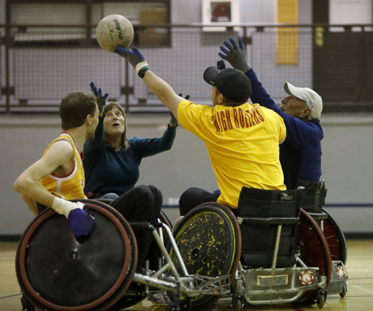 Bradley Boe, High Rollers rugby team founder and player, left, plays wheelchair rugby at Dula G ...