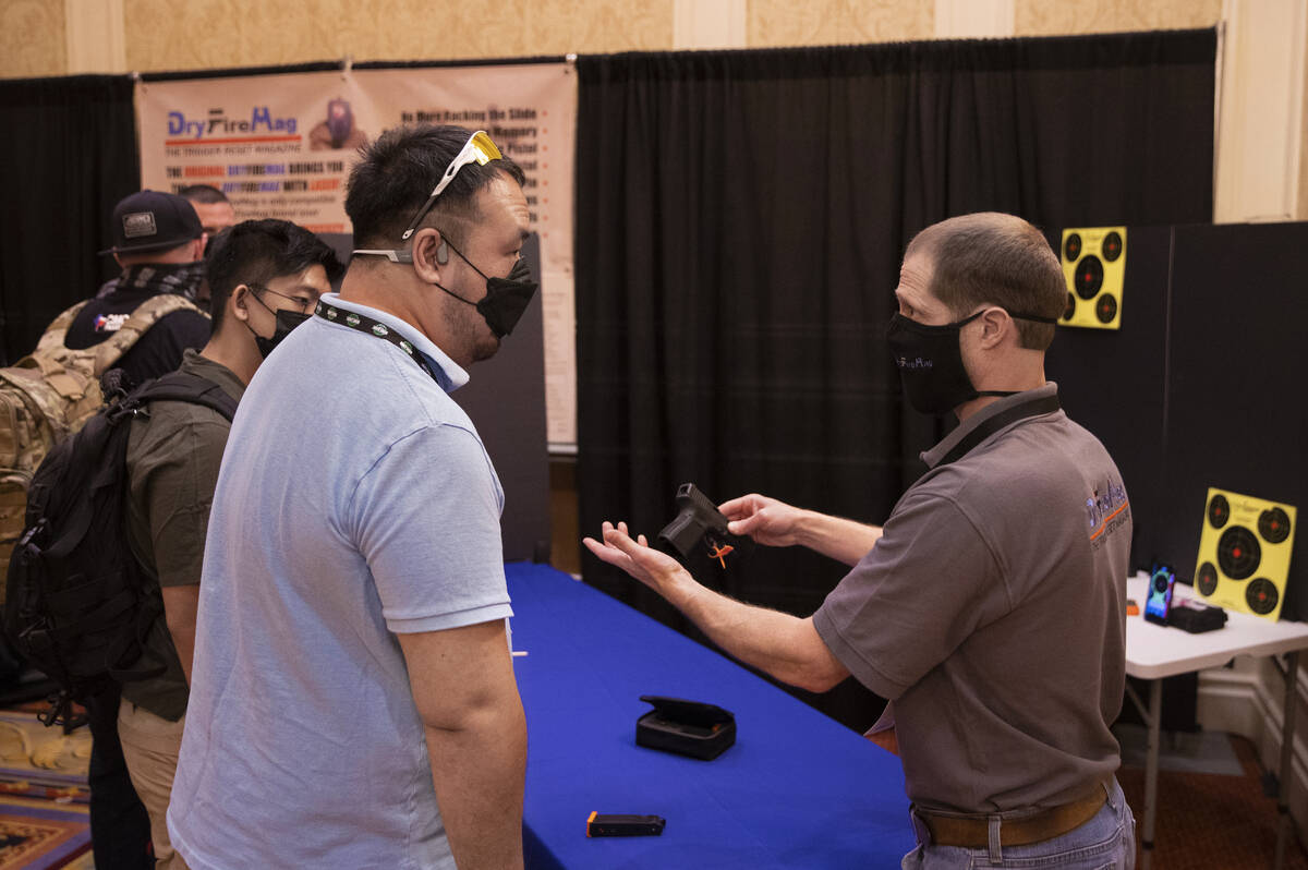 John Seigler, right, with DryFireMag, speaks with Jeffery Wong during the SHOT Show shooting, h ...