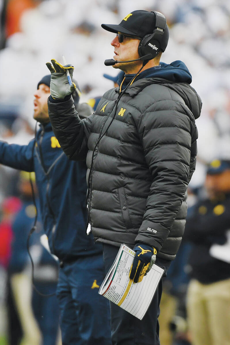 Michigan head coach Jim Harbaugh watches from the sideline during an NCAA college football game ...