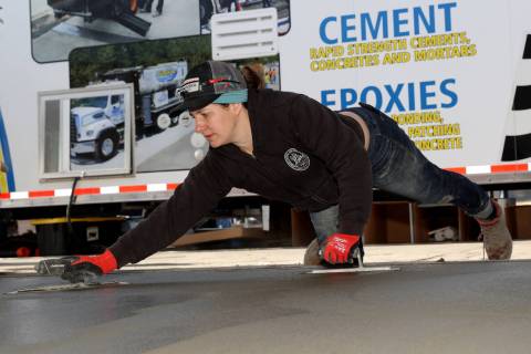 Liz Nichols of Portland, Ore., smooths a concrete slab in the Operative Plasterers’ and Cemen ...