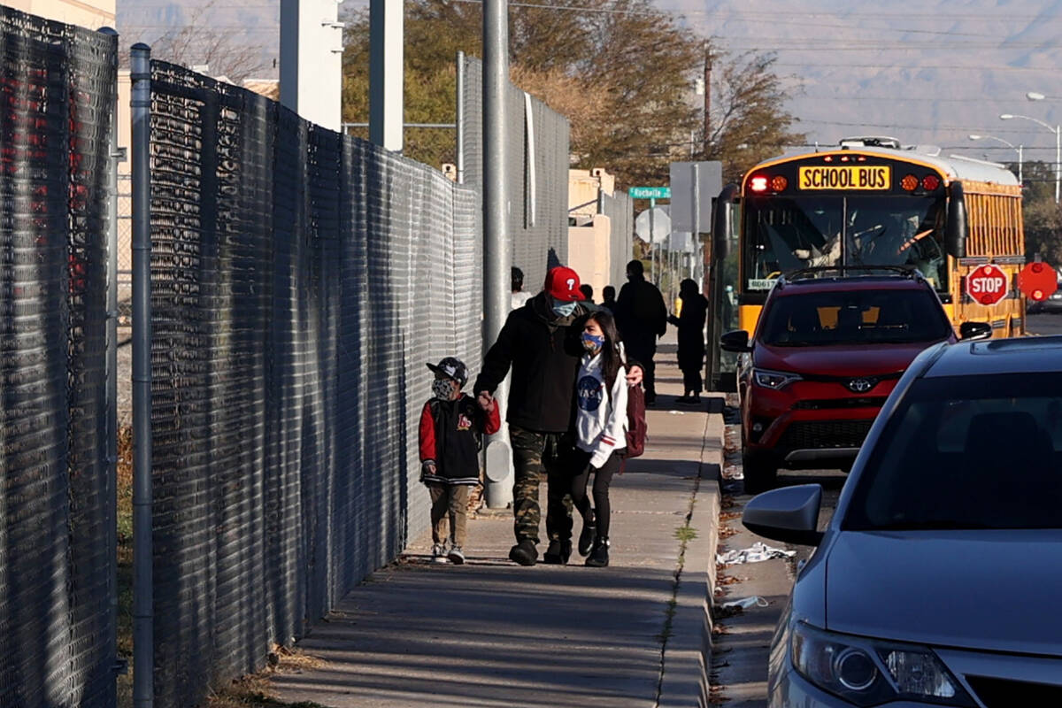 Parents drop their kids off at Rowe Elementary School in Las Vegas Wednesday, Jan. 19, 2022, af ...