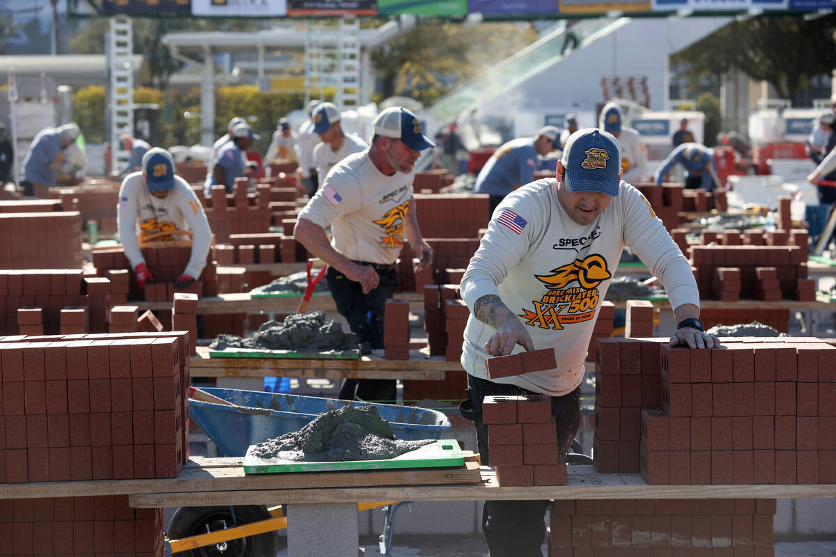 Tenders stack bricks for their masons as they compete in the Bricklayer 500 during the World of ...