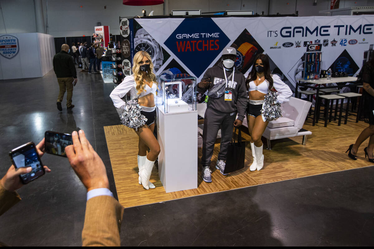 Ray Smith, of Charleston, S.C., poses with Raiderettes Camryn A., left, and Audrey M., next to ...