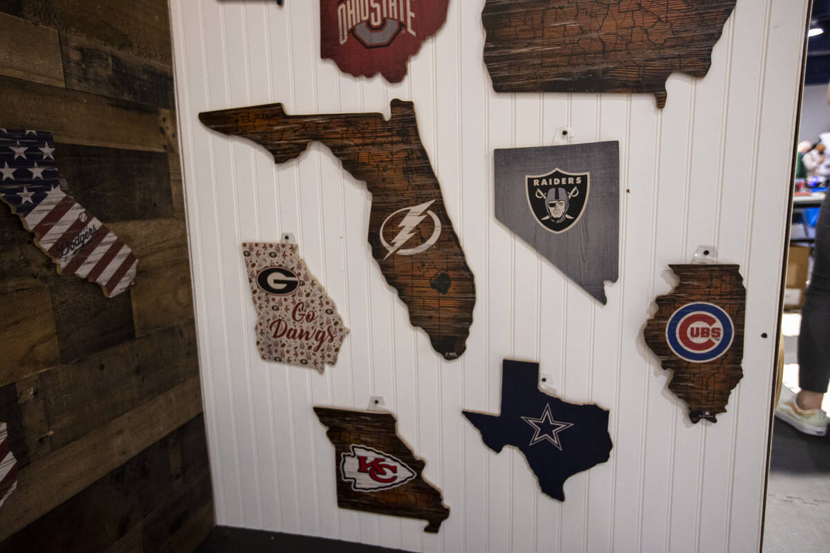 Wooden wall plaques are seen at the Fan Creations booth during the Sports Licensing & Tailg ...