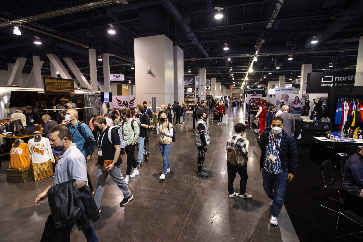 People walk the show floor during the Sports Licensing & Tailgate Show at the Las Vegas Con ...