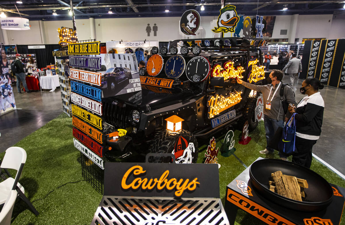 Ken Adelson, of Scottsdale, Ariz., checks out a sign at the Gameday Ironworks booth is seen dur ...