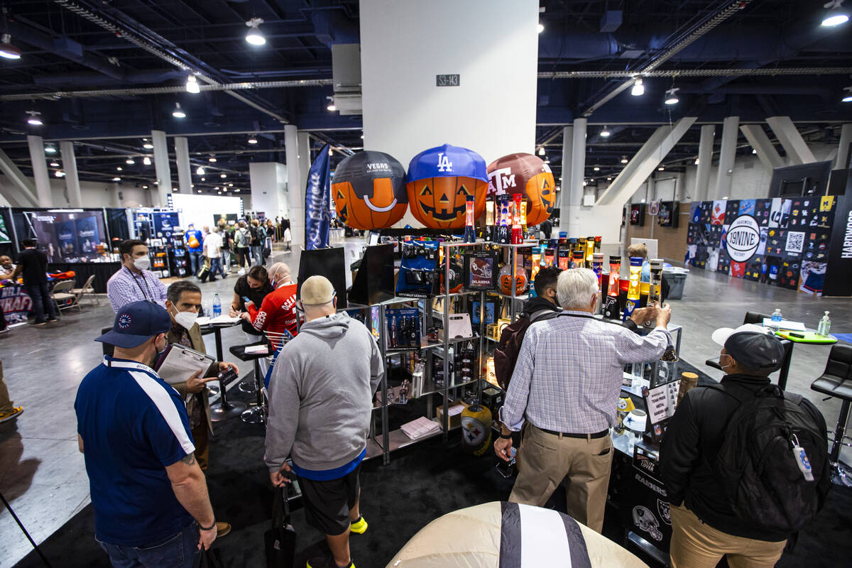 Attendees check out the Siskiyou Sports booth during the Sports Licensing & Tailgate Show a ...