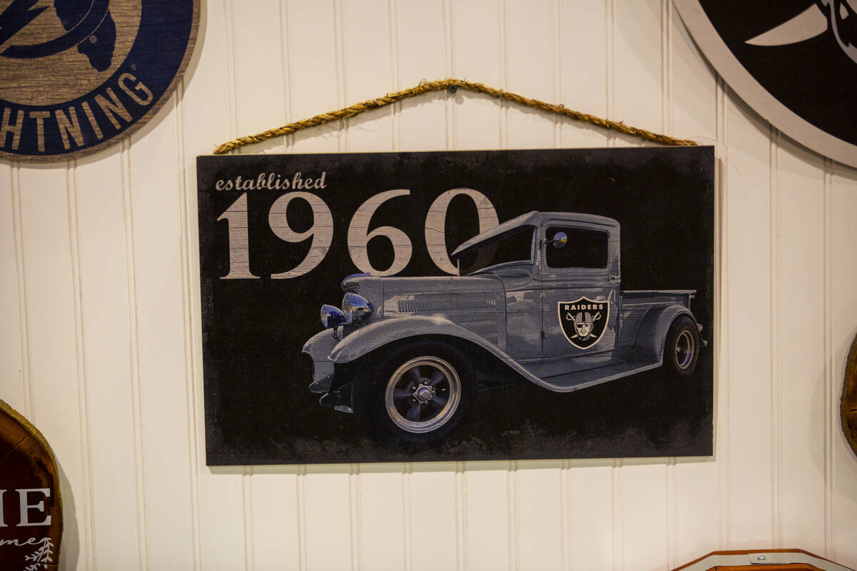 A wooden Raiders wall plaque is seen at the Fan Creations booth during the Sports Licensing &am ...