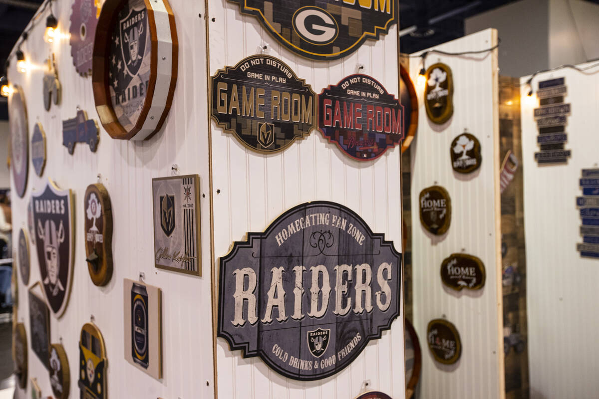 Wooden wall plaques are seen at the Fan Creations booth during the Sports Licensing & Tailg ...