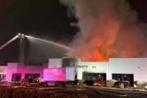 Firefighters battle a large fire at Electric Liquidators, 100 N. Pecos Road, early Friday, Jan. ...
