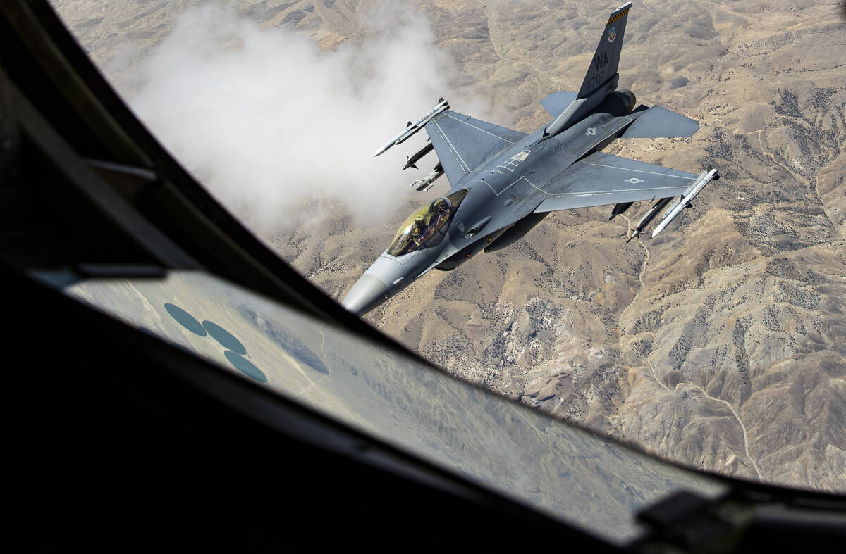 An F-16 is seen after being is refueled in-flight by a KC-135 Stratotanker flying around the Ne ...