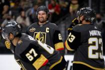 Golden Knights right wing Mark Stone (61) smiles in between the action next to left wing Max Pa ...