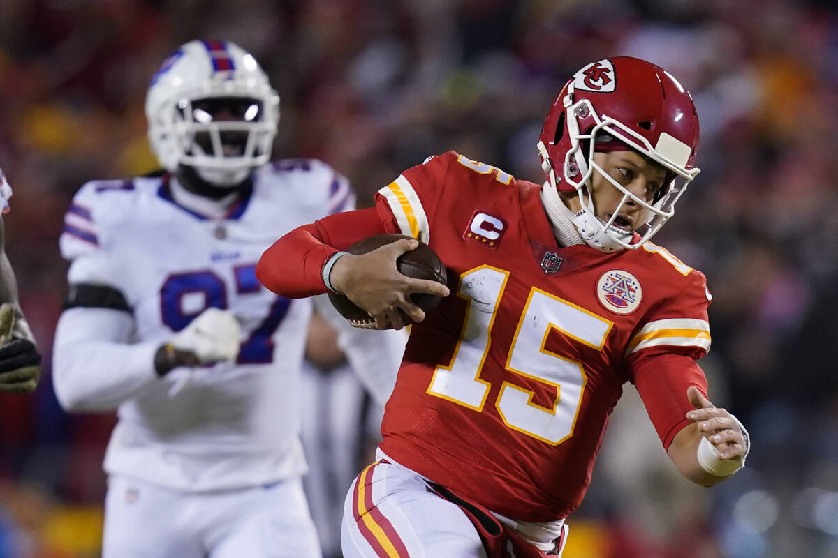 Kansas City Chiefs quarterback Patrick Mahomes (15) scrambles up field during the first half of ...