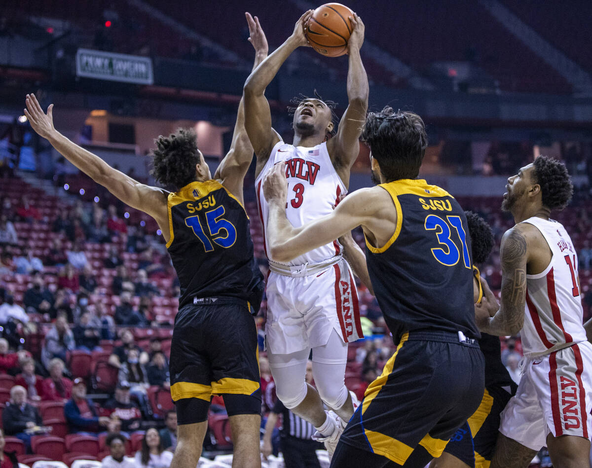 UNLV Rebels guard Bryce Hamilton (13) looks to shoot between San Jose State Spartans forward Tr ...