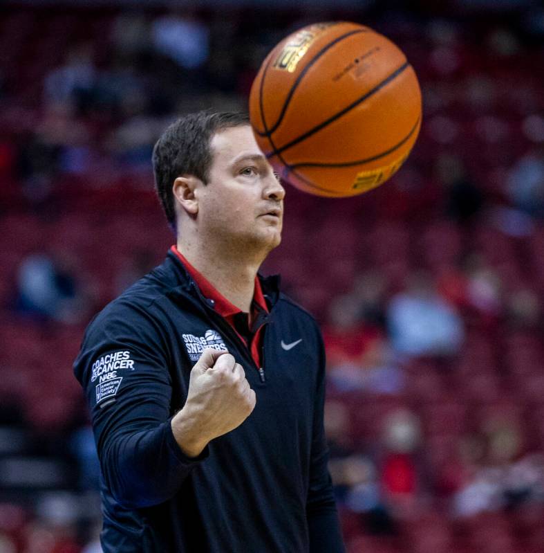 UNLV Rebels head coach Kevin Kruger tosses the ball onto the court versus San Jose State Sparta ...