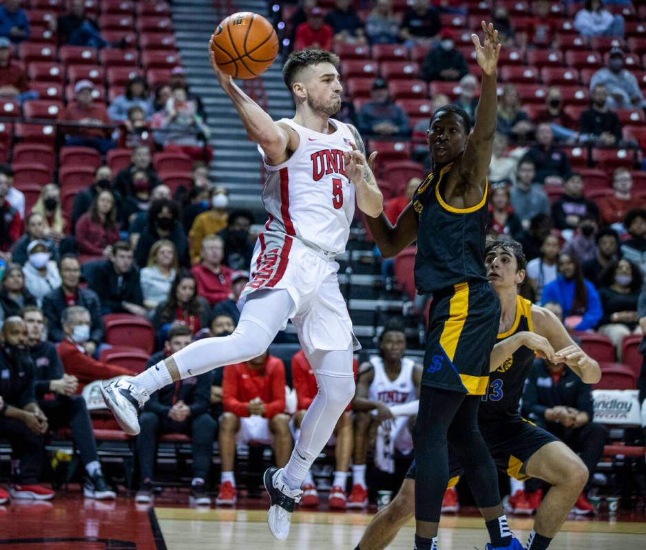 UNLV Rebels guard Jordan McCabe (5) elevates for a pass around San Jose State Spartans guard Om ...