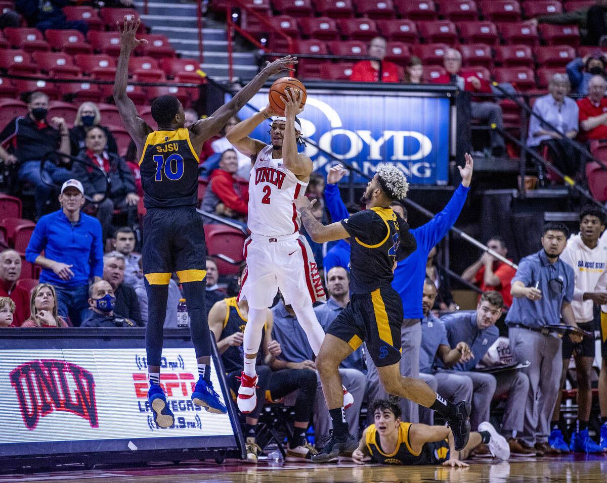 UNLV Rebels guard Justin Webster (2) passes from a double team by San Jose State Spartans guard ...