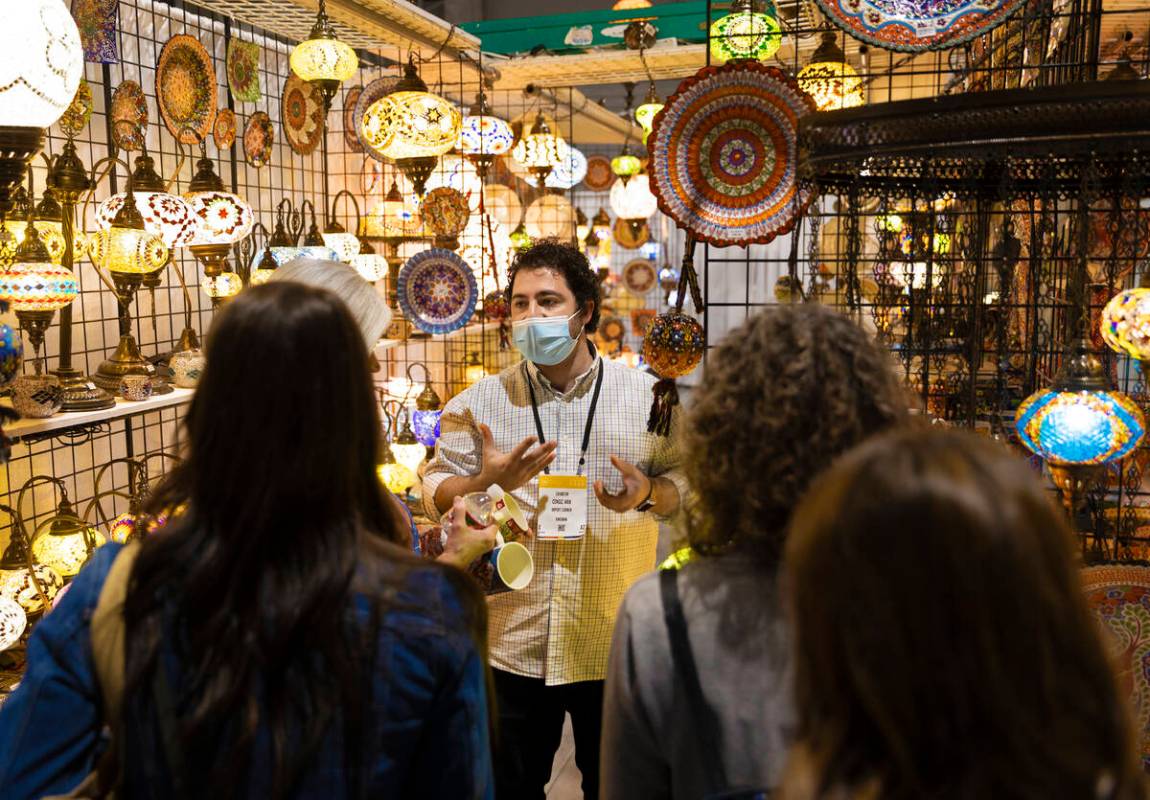 Cengiz Arik, middle, with Import Corner, talks with conventiongoers during the Las Vegas Market ...