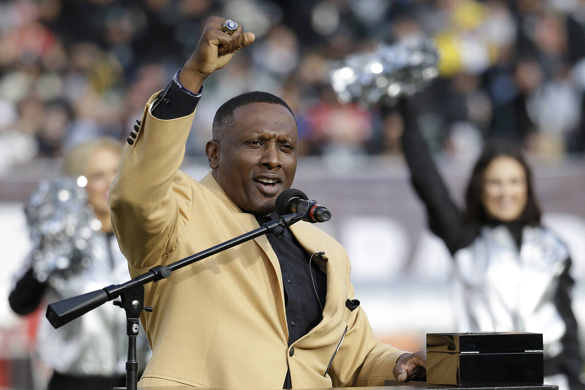 Former Oakland Raiders wide receiver Tim Brown gestures while speaking at a ceremony honoring h ...