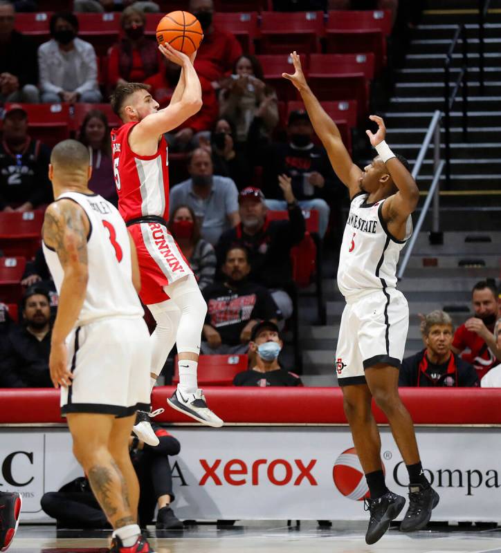 UNLV's Jordan McCabe shoots against San Diego State's Lamont Butler during an NCAA college bask ...