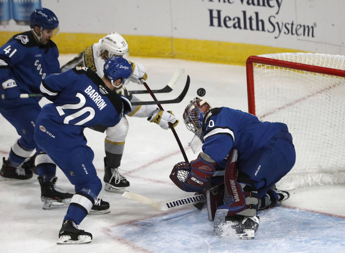 Henderson Silver Knights center Maxim Marushev (77) tries to shoot against Colorado Eagles goal ...