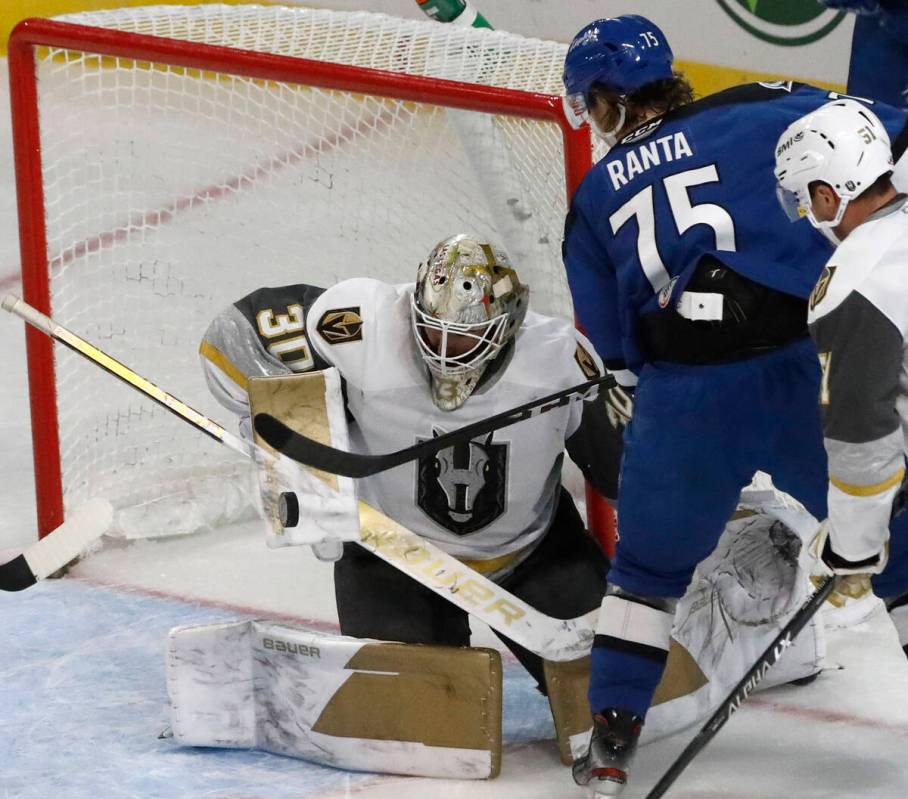 Henderson Silver Knights goalie Jiri Patera (30) makes a save against Colorado Eagles right win ...