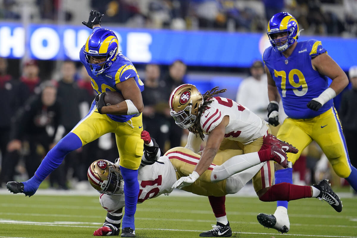 Los Angeles Rams' Kendall Blanton, left, is stopped by San Francisco 49ers' Azeez Al-Shaair, bo ...