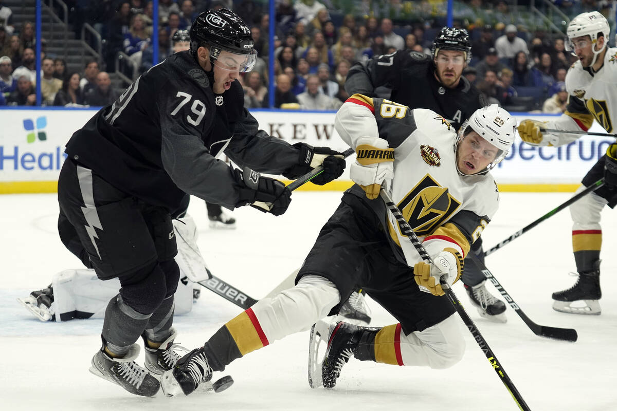 Tampa Bay Lightning center Ross Colton (79) knocks down Vegas Golden Knights center Mattias Jan ...