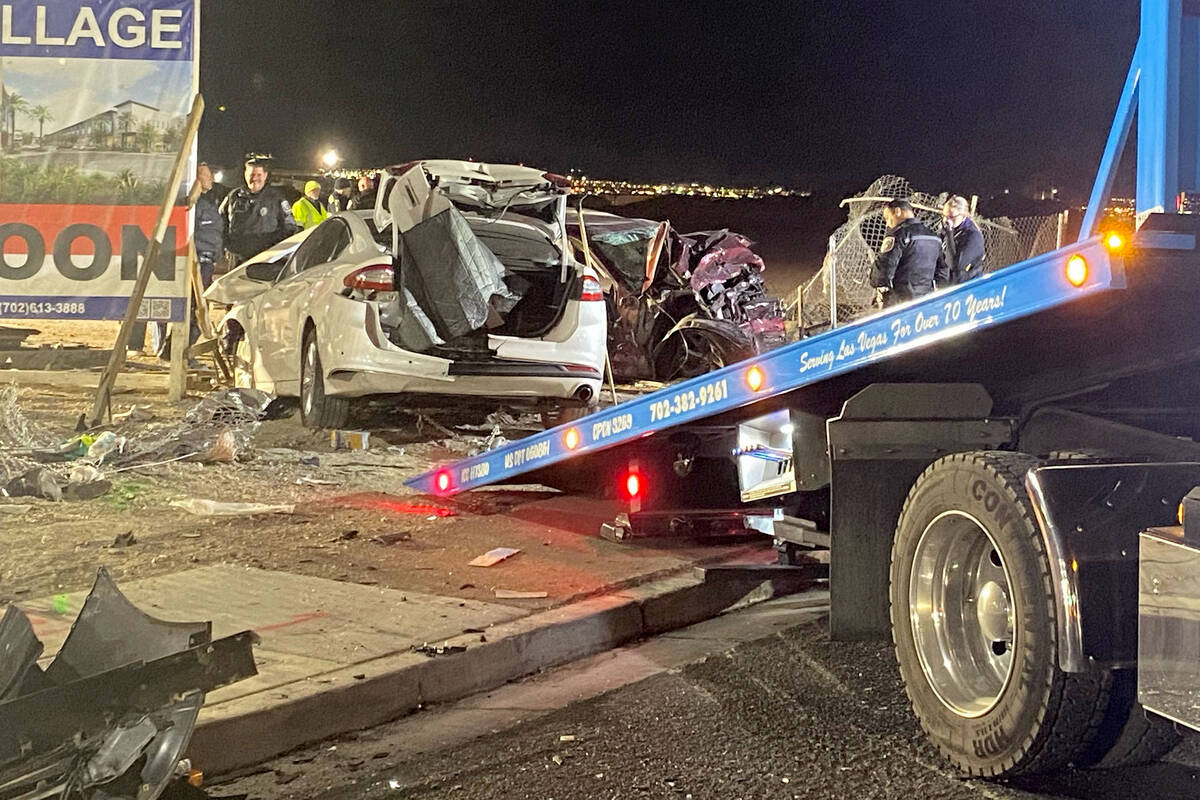 Authorities get set to tow a vehicle involved a six-car crash at the scene of a fatal crash on ...