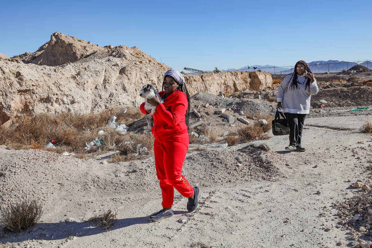 Z’kya Smith, 15, left, carries Magic next to her mother Tameka Henry, right, on Sunday, ...